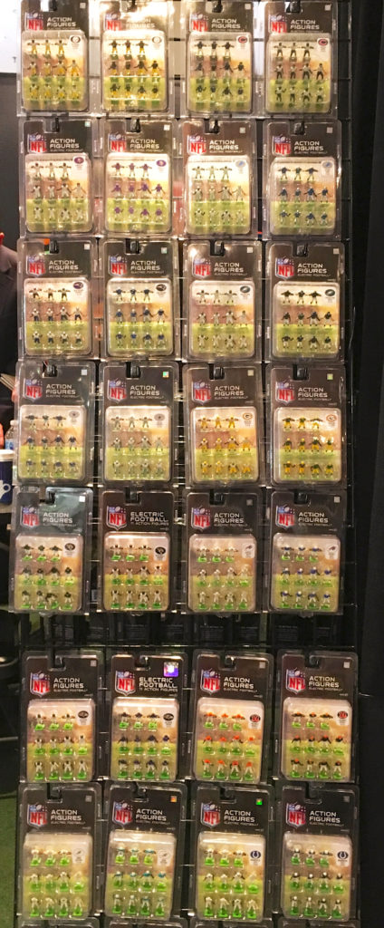 <alt img="Tall rack of Tudor Games NFL Electric Football teams at 2018 Toy Fair">